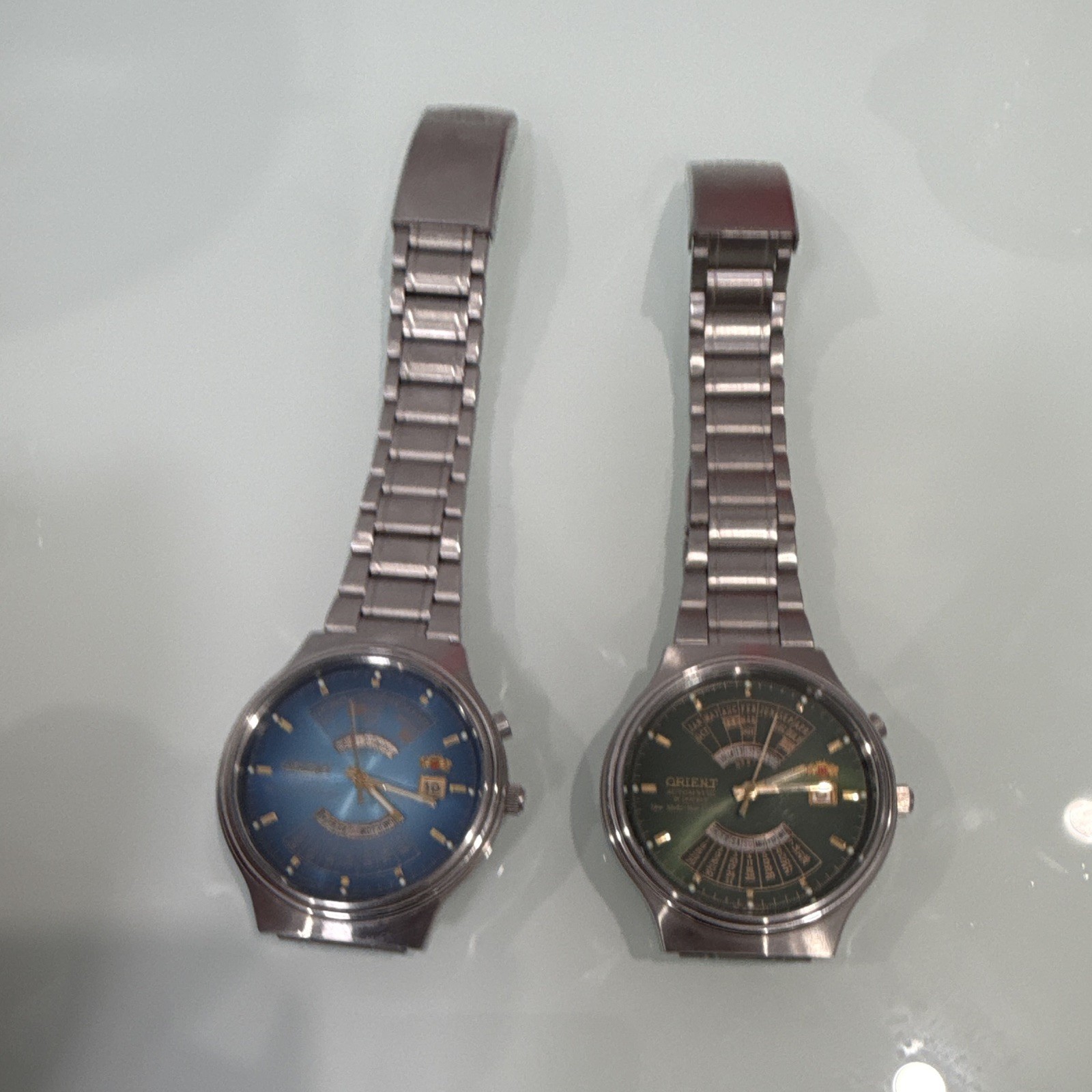 Orient Multi Year Lot of 2 Automatic Day/Date SS Bracelet Blue & Green Dial